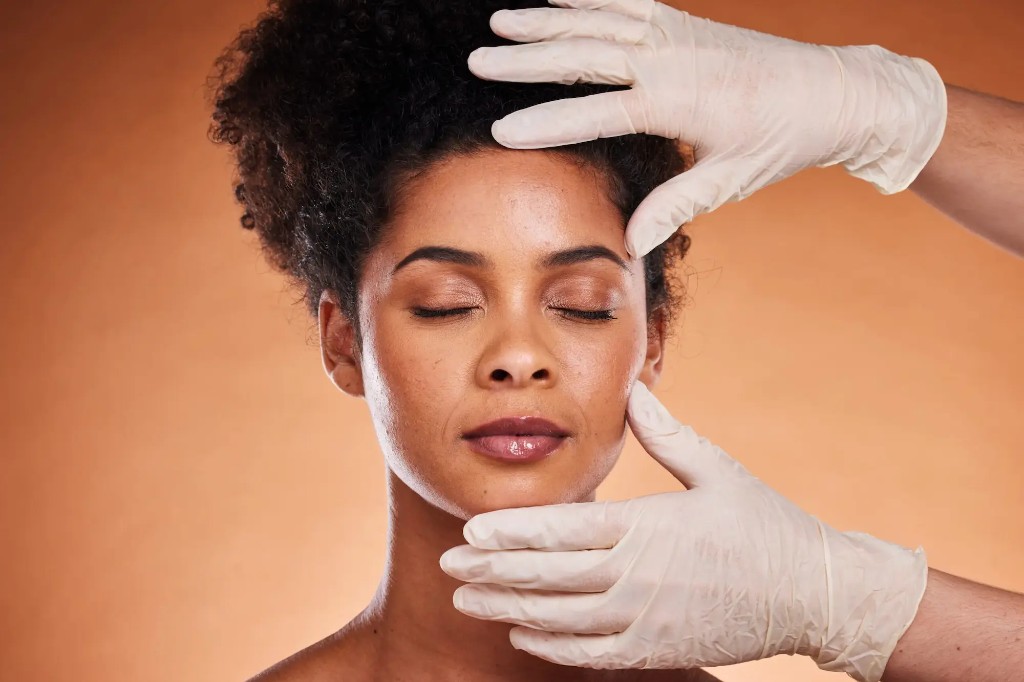 Facial treatment with gloved hands